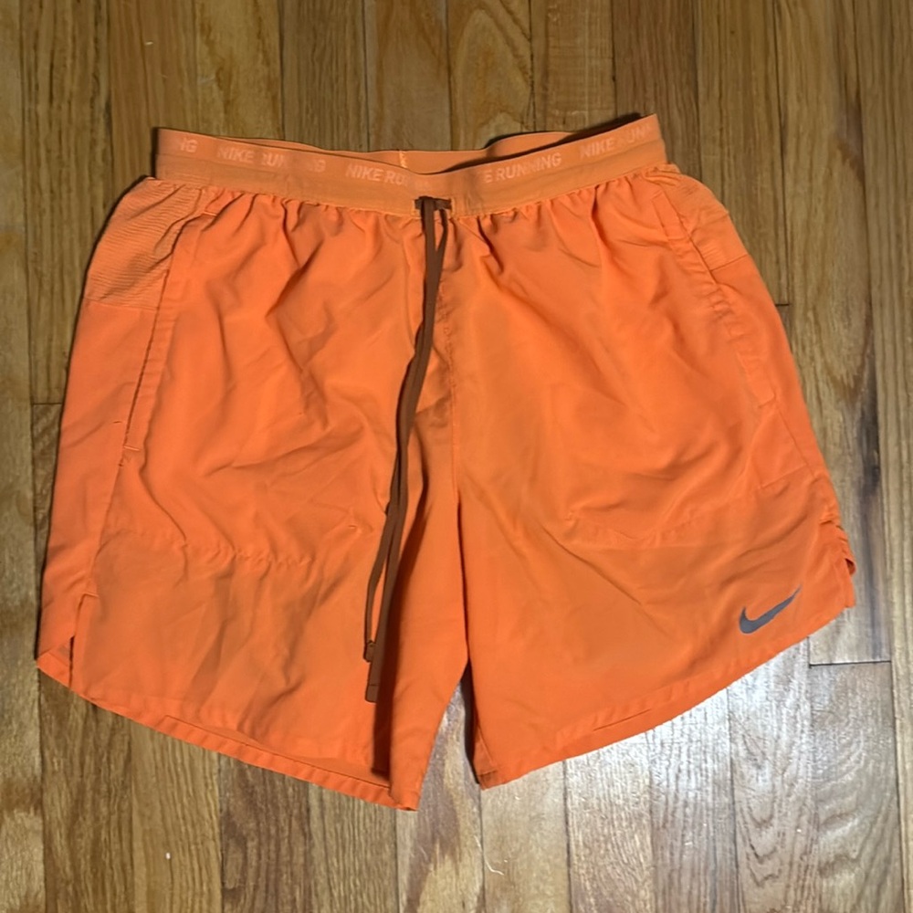 Men’s orange Nike running shorts
